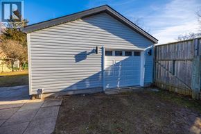 Sarnia apartment for rent - A two-car garage with a blue door is situated in a residential area.