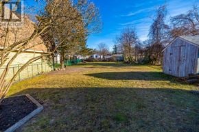 Sarnia apartment for rent - A backyard with a shed and a fence.