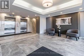Mississauga (Meadowvale) condo for rent - A brokerage office with two grey armchairs and a painting on the wall.