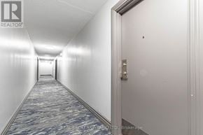Mississauga (Meadowvale) condo for rent - A hallway with a carpeted floor and white walls.