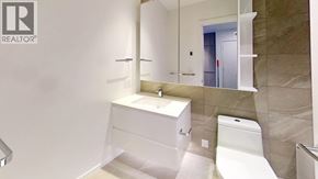 Richmond apartment for rent - A white bathroom with a sink, toilet and mirror.