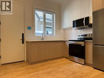 Richmond apartment for rent - A kitchen with wooden cabinets and stainless steel appliances.