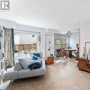 Ottawa apartment for rent - A living room with a grey couch and a wooden side table.