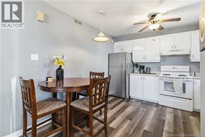 Moncton multi-family for rent - A kitchen with a table and chairs.
