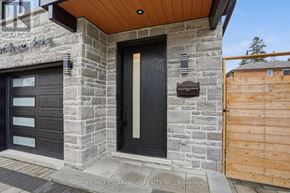 Mississauga (Port Credit) apartment for rent - A modern house with a black door and a stone wall.