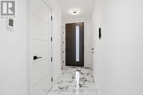 Mississauga (Port Credit) apartment for rent - A hallway with a marble floor and white walls.