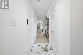 Mississauga (Port Credit) apartment for rent - A hallway with a marble floor and white walls.