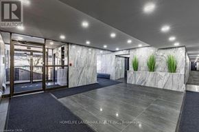 Burlington (Brant) multi-family for rent - A lobby with a marble wall and a plant on top.