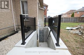 Barrie (Innis-Shore) apartment for rent - A black metal fence with a gate is in front of a brick house.