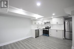 Barrie (Innis-Shore) apartment for rent - A kitchen with white cabinets and stainless steel appliances.