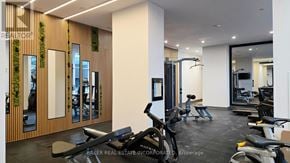 Burlington (Lasalle) condo for rent - A gym with a row of treadmills and a row of stationary bikes.
