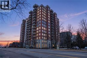 Burlington condo for rent - A tall apartment building with a sunset in the background.