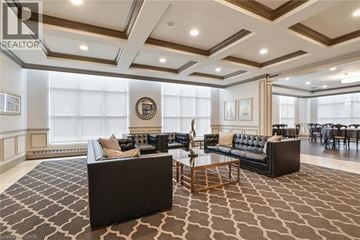 Burlington condo for rent - A living room with a black couch and a wooden coffee table.