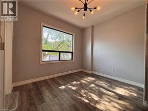 Hamilton apartment for rent - A room with a window and a wooden floor.