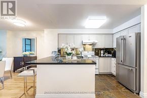 Toronto (Willowdale East) condo for rent - A modern kitchen with a large island and stainless steel appliances.