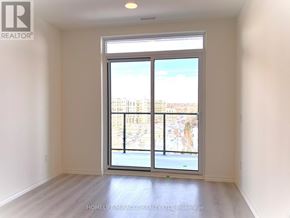 Guelph (Willow West/Sugarbush/West Acres) condo for rent - A room with a large window and a view of a cityscape.