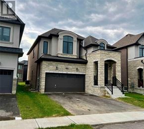 Woodstock (Woodstock - North) apartment for rent - A house with a garage and a driveway in front.