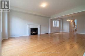 Woodstock (Woodstock - North) apartment for rent - A large, empty room with a fireplace and wooden floors.