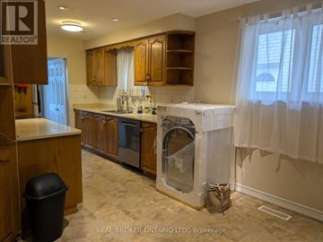 Mississauga (Applewood) apartment for rent - A kitchen with wooden cabinets and a black trash can.