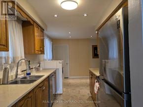 Mississauga (Applewood) apartment for rent - A kitchen with wooden cabinets and a stainless steel refrigerator.