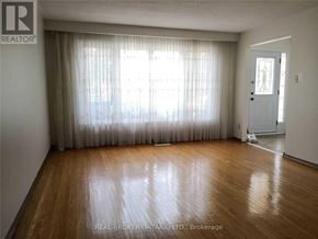 Mississauga (Applewood) apartment for rent - A room with wooden flooring and a door leading to another room.