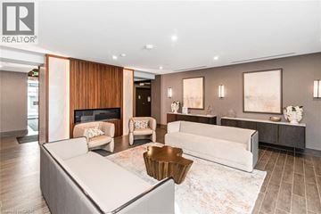 Waterdown condo for rent - A living room with a white couch and a fireplace.