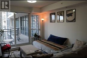 Richmond Hill (Doncrest) condo for rent - A bedroom with a bed, a chair, and pictures on the wall.