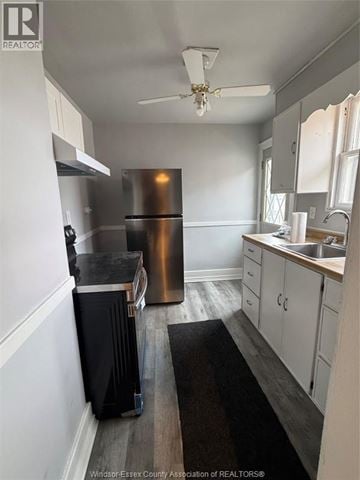 Windsor apartment for rent - A kitchen with a stainless steel refrigerator and wooden floors.