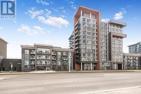 Hamilton (Waterdown) condo for rent - A modern apartment building with a glass facade is the main focus of the image.