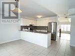 Barrie (Painswick North) townhouse for rent - A realtor sign is on the wall of a kitchen.