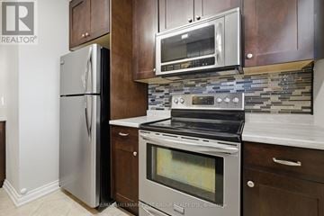 Whitby (Williamsburg) apartment for rent - A modern kitchen with a stainless steel refrigerator and oven.