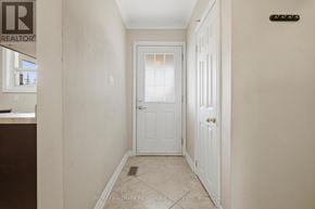 Whitby (Williamsburg) apartment for rent - A hallway with a white door and a brown counter.