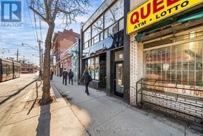 Toronto (Kensington-Chinatown) multi-family for rent - A street view with a Quee Lotto sign on a building.