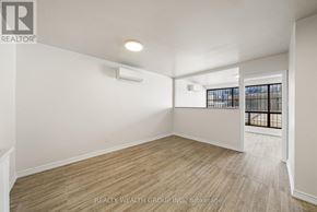 Toronto (Kensington-Chinatown) condo for rent - A room with a window and a door leading to a balcony.