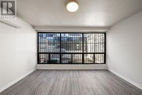 Toronto (Kensington-Chinatown) condo for rent - A room with a window and a wooden floor.