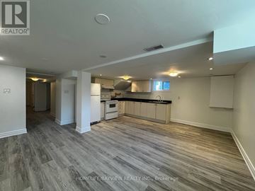 Newmarket (Bristol-London) apartment for rent - A spacious kitchen and living room with wood flooring and white walls.