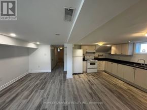 Newmarket (Bristol-London) apartment for rent - A spacious kitchen with white appliances and wooden flooring.