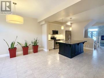 London North (North R) townhouse for rent - A kitchen with a black counter and three red pots.