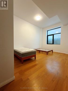 Toronto (Bathurst Manor) apartment for rent - A bedroom with a bed and a bench in it.