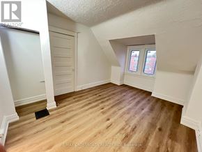 Toronto (South Riverdale) apartment for rent - A room with wooden flooring and a window with two panes of glass.