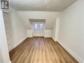 Toronto (South Riverdale) apartment for rent - A room with wooden flooring and a window.