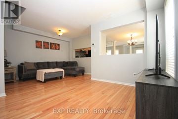 Milton (De Dempsey) apartment for rent - A living room with a grey couch and a wooden floor.