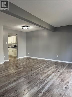 Waterloo townhouse for rent - A room with wooden flooring and a white door in the background.