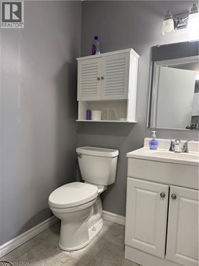 Waterloo townhouse for rent - A white toilet sits next to a white sink in a bathroom.