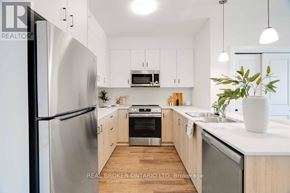 London North (North B) multi-family for rent - A modern kitchen with stainless steel appliances and wooden cabinets.