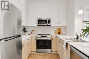 London North (North B) multi-family for rent - A modern kitchen with wooden cabinets and stainless steel appliances.