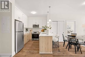 London North (North B) multi-family for rent - A modern kitchen with wooden floors and white walls.
