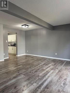 Waterloo townhouse for rent - A room with wooden flooring and a white door in the background.