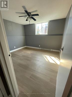 Welland (Lincoln/Crowland) multi-family for rent - A room with a ceiling fan and wooden flooring.