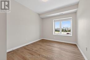 Woodstock (Woodstock - South) apartment for rent - A room with a window showing a view of houses and trees outside.